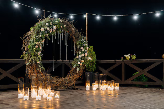 huge-decorative-circle-made-willow-greenery-pale-orange-roses-with-burning-candles_8353-10644